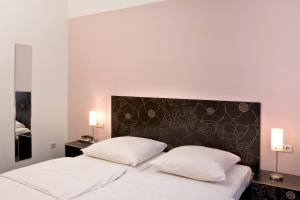 Postel nebo postele na pokoji v ubytování Hotel Aigner
