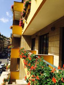 a building with flowers on the side of it at Hotel Mythos in Milan
