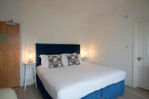 A bed or beds in a room at One Helena Road Serviced Apartments 