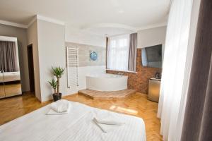 Posteľ alebo postele v izbe v ubytovaní R&B APARTMENTS POZNAŃ
