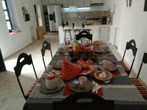 a table with food and drinks on top of it at Dar Ennour Djerbahood Erriadh in Houmt Souk