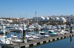 a bunch of boats docked in a harbor at El Cantil in Isla Cristina