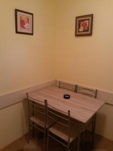 a table in a room with two chairs around it at Apartman Sucuraj in Sućuraj +15 photos
