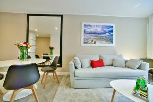 a living room with a couch and a table at Park Design - Apartments M&M (Polanki Park) in Kołobrzeg