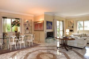 a living room with a couch and a table and chairs at La Via Romana Boutique Guest House in Bordighera