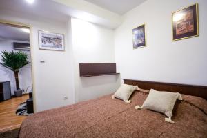 a bedroom with a bed with two pillows on it at Apartment Marica Skadarlija in Belgrade