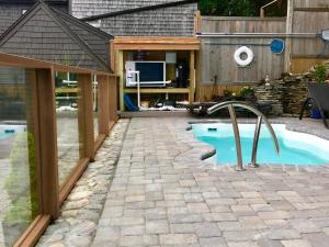 a backyard with a swimming pool and a house at The Clarendon House in Provincetown
