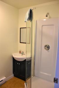 a bathroom with a sink and a shower at North Coast Trail Backpackers Ltd in Port Hardy