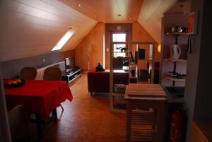 a kitchen and dining room with a table and a couch at De Rosmolen in Ertvelde