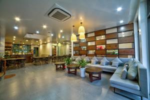 a lobby with a couch and tables and a bar at Lustig Hostel in Sa Pa