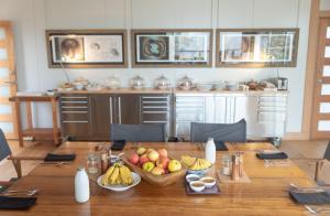 a wooden table with a bowl of fruit on it at Truffle Lodge Dinner Bed Breakfast Glamping in Gretna