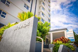 a building with a sign on the side of it at 84 The Spit Holiday Apartments in Mooloolaba