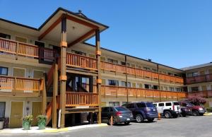 a large apartment building with cars parked in a parking lot at Nites Inn in Seattle