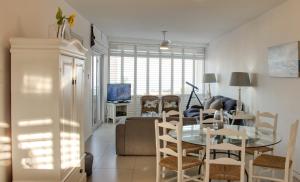 a living room with a table and a dining room at 34 Sea Lodge in Durban
