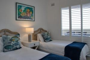 a bedroom with two beds and a window at 34 Sea Lodge in Durban +23 photos