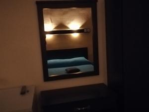 a mirror above a sink in a bathroom at Stella Rooms in Tolo