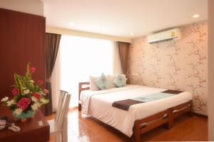 曼谷的住宿－拉查達畢莉斯酒店，酒店客房设有床和窗户。