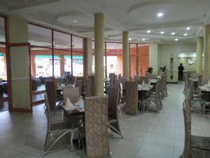a dining room with tables and chairs in a restaurant at Crossroads Hotel in Lilongwe