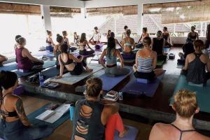 a group of people sitting in a yoga class at Ecosfera Hotel & Spa in Canggu