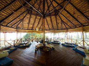 a large straw hut with blue couches in a room at The Barefoot At Havelock in Havelock Island