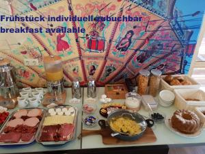 a table with a buffet of food and drinks at Chalet Bad Tölz in Bad Tölz