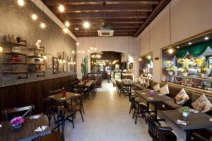 a restaurant with tables and chairs in a room at Kimberley Hotel Georgetown in George Town