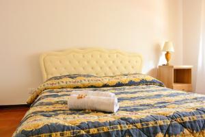 a bed with a towel on top of it at Florinda B&B Viareggio in Viareggio