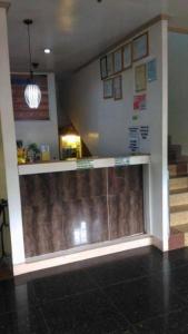 a lobby with a counter and stairs in a building at Asia Novo Boutique Hotel - Daet in Daet
