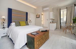 a bedroom with a large bed and a table at Lear Liston Suite in Corfu Town