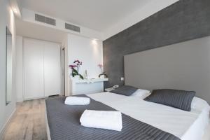 a bedroom with a large bed with two pillows at Boutique Hotel Bali in Lido di Jesolo +50 photos