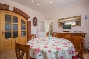 een eetkamer met een tafel en een televisie bij Apartments Janko in Rovinj