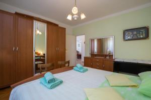 a bedroom with a large bed with blue towels on it at Apartments Janko in Rovinj