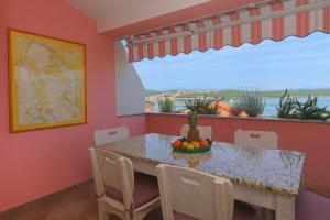 a dining room with a table with a bowl of fruit at Apartment Klimno View Point in Klimno +20 photos