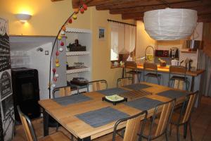 a kitchen with a table and chairs in a room at Le clos des Frasses in Chainaz-les-Frasses