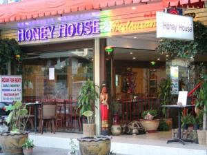 a harvey house restaurant with plants in front of it at Honey House 2 in Bangkok