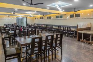 a dining room filled with tables and chairs at Hotel Sree Devi Madurai in Madurai