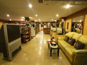 a living room with a couch and a tv in a store at Honey House 2 in Bangkok