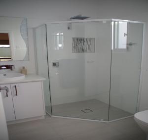 a white bathroom with a shower and a sink at Laguna View in Port Lincoln