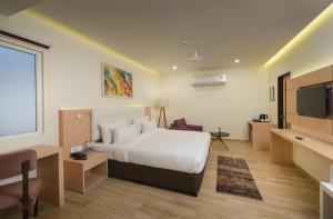 a hotel room with a bed and a flat screen tv at 10 Park Street Bed & Breakfast in Gorakhpur +22 photos
