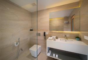 a bathroom with a toilet and a sink and a shower at 10 Park Street Hotel & Banquets in Gorakhpur