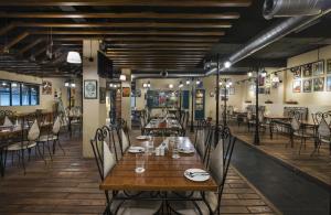 a dining room with a wooden table and chairs at 10 Park Street Bed & Breakfast in Gorakhpur