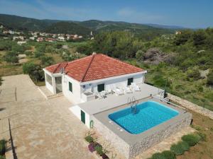 an aerial view of a house with a swimming pool at Robinzon Villa Zavala in Povlja