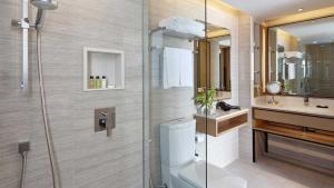 a bathroom with a shower and a toilet and a sink at Amari Phuket in Patong Beach