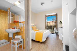 a bedroom with a bed and a sink and a mirror at Il Palmento Relais in Piano di Sorrento