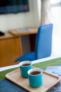 two cups of coffee on a tray on a table at Summit View Kowloon in Hong Kong