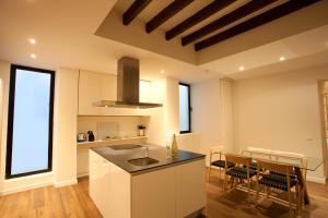 a kitchen with a stove top oven and a sink at Hotel Bosch Boutique in Palma de Mallorca