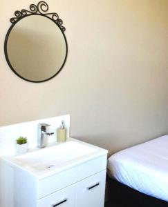 a bathroom with a sink and a mirror on the wall at Centennial Inn on Bathurst in Launceston