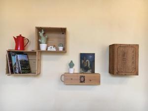 a wall with wooden shelves on a wall at Case Nell' Aia in Poggibonsi
