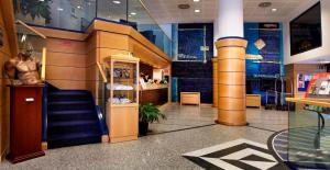 a store with a staircase in a mall at Pacific Hotel Fortino in Turin