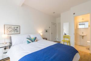 a bedroom with a large bed with a blue blanket at Spacious and chic flat in Angel in London